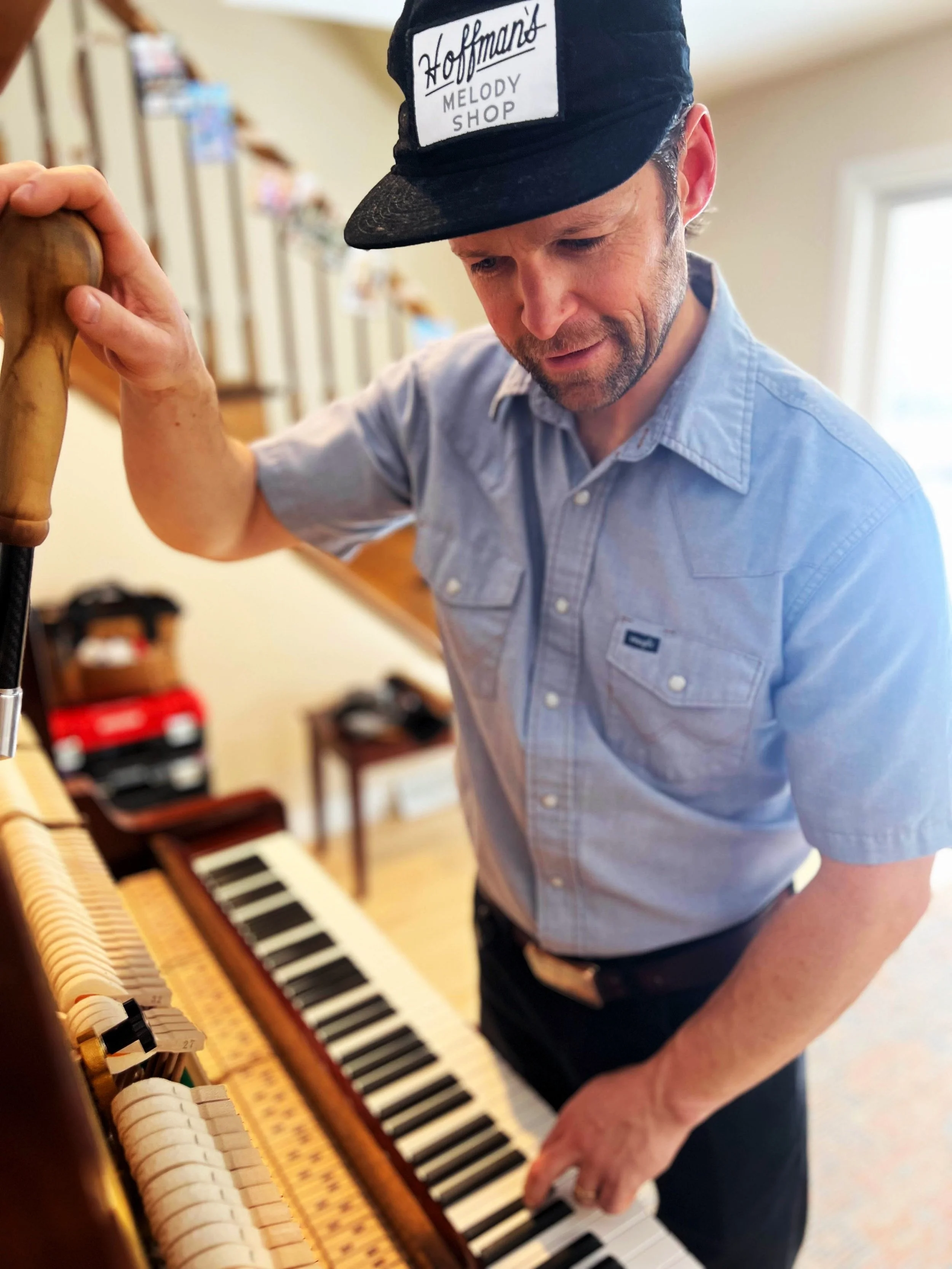 Matt Hoffman inspecting the action inside a piano